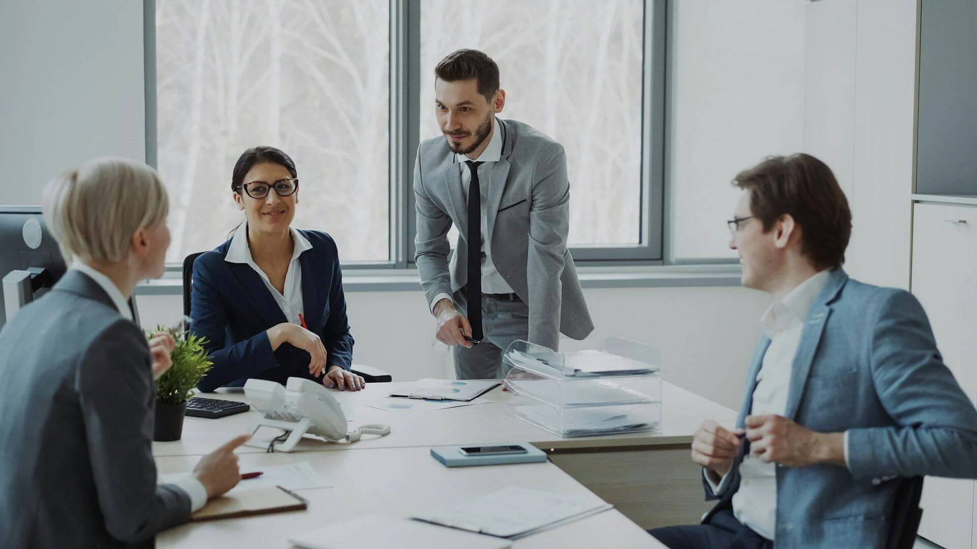 Business team in discussion around an office desk